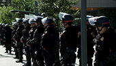 Still image of Peace keepers form a security barricade.